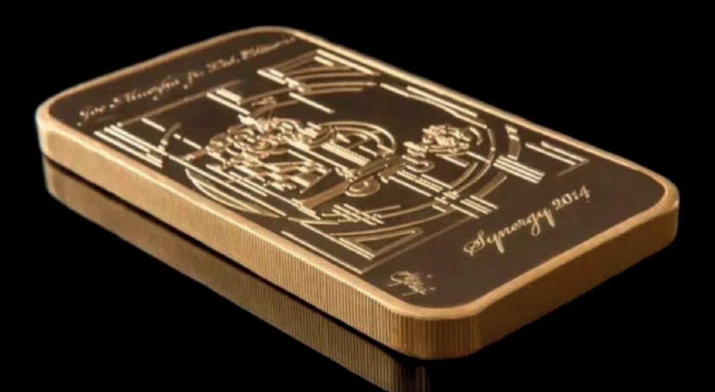 Gold bar with an embossed motif and the signature of Joe Muczka jr.