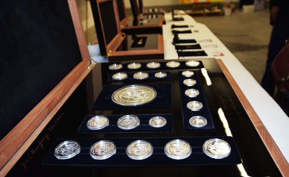 Case with a series of silver coins based on motifs by Joe Muczka jr.