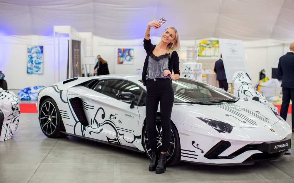 White sports car with line graphics by Joe Muczka jr. at the trade fair